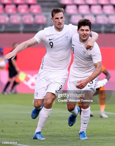 Chris Wood of Team New Zealand celebrates with teammate Liberato Cacace after scoring their side's second goal during the Men's First Round Group B...