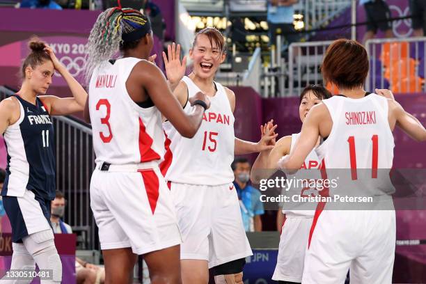 Risa Nishioka of Team Japan celebrates victory with team mates after defeating Team France during the Women's Pool Round match between Japan and...