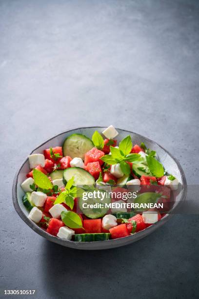 healthy vegetarian watermelon salad bowl with feta cheese, cucumber and parsley - feta stock pictures, royalty-free photos & images