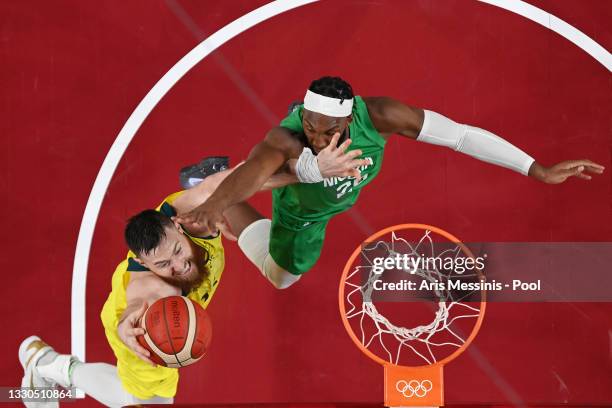 Aron Baynes of Team Australia drives to the basket against Josh Okogie of Team Nigeria in the first half of their Men's Preliminary Round Group B...