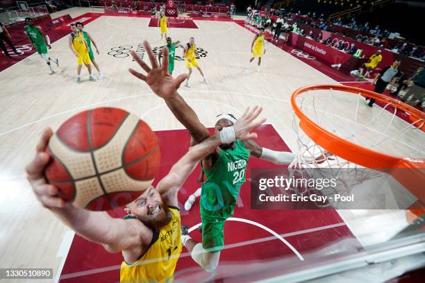 Aron Baynes of Team Australia drives to the basket against Josh Okogie of Team Nigeria in the first half of their Men's Preliminary Round Group B...