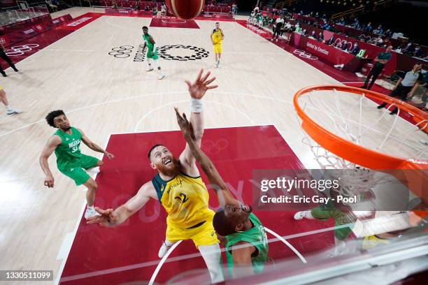 Aron Baynes of Team Australia and Ekpe Udoh of Team Nigeria battle for possession of a rebound in the first half of their Men's Preliminary Round...