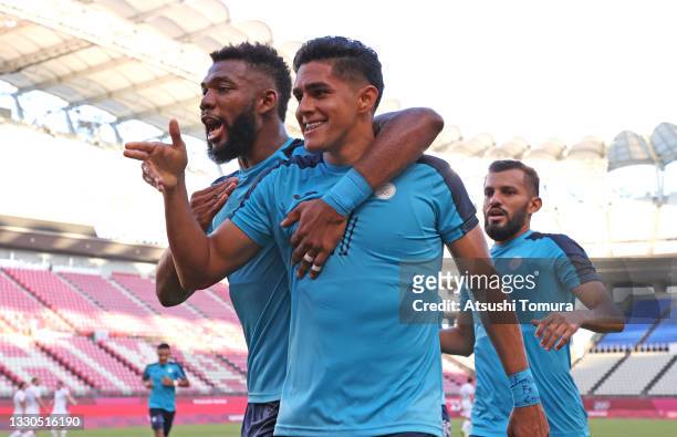 Luis Palma of Team Honduras celebrates with teammate Jorge Benguche after scoring their side's first goal during the Men's First Round Group B match...