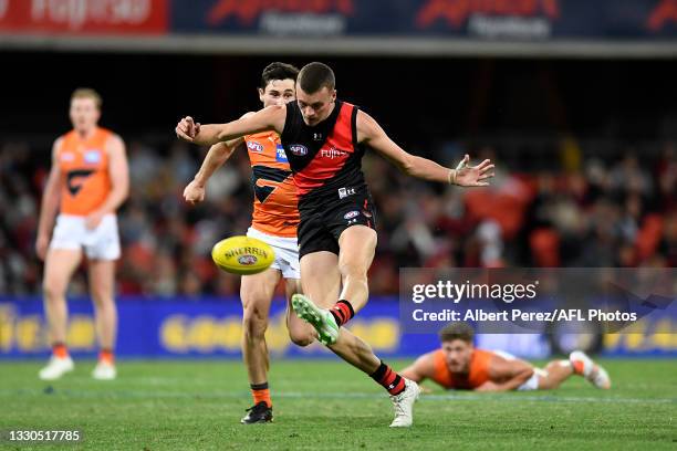 Nik Cox of the Bombers kicks the ball during the round 19 AFL match between Essendon Bombers and Greater Western Sydney Giants at Metricon Stadium on...