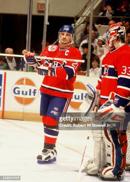 Montreal Canadiens captain Guy Carbonneau talks with Patrick Roy during game vs Hartford Whalers, Hartford CT 1992.