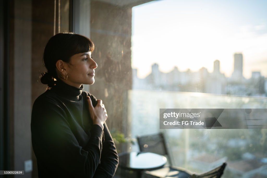 Young woman contemplating at home