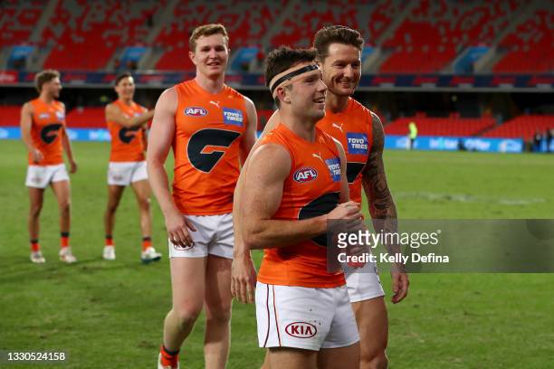 Xavier O'Halloran of the GWS Giants celebrates the win with Daniel Lloyd of the GWS Giants during the round 19 AFL match between Essendon Bombers and...