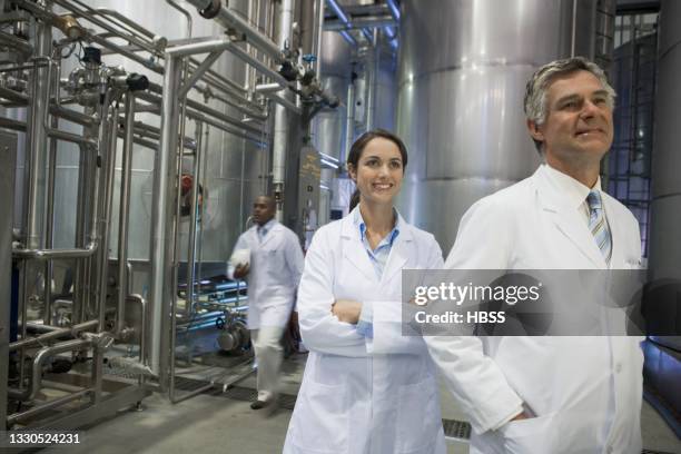 smiling scientists in factory - thinktank stock pictures, royalty-free photos & images