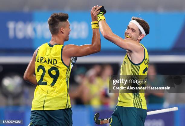Tim Brand of Team Australia celebrates with teammate Flynn Andrew Ogilvie after scoring their team's seventh goal during the Men's Preliminary Pool A...