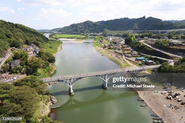 General view of the peloton pass through Ogura Bridge on Sagami river during the Women's road race on day two of the Tokyo 2020 Olympic Games at Fuji...