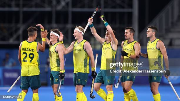 Tim Brand of Team Australia celebrates with team mates after scoring their team's seventh goal during the Men's Preliminary Pool A match between...