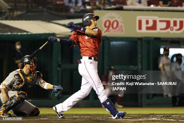 Outfielder Yuki Yanagita of Samurai Japan hits a RBI single to make it 3-0 in the 6th inning during the practice game between Samurai Japan and...