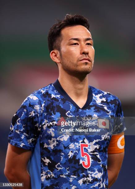 Maya Yoshida of Team Japan looks on as he stands for the national anthem prior to the Men's First Round Group A match between Japan and Mexico on day...