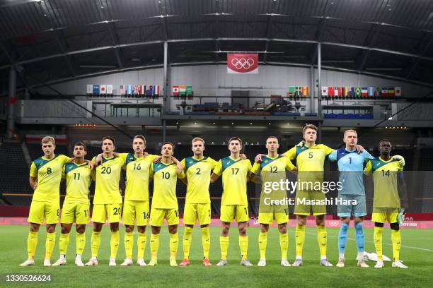 Players of Team Australia stand for the national anthem prior to the Men's First Round Group C match between Australia and Spain on day two of the...