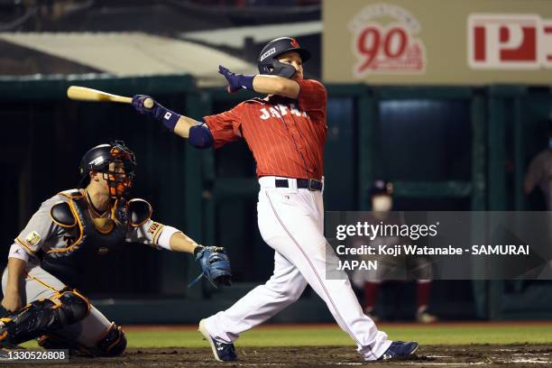 Outfielder Masataka Yoshida of Samurai Japan hits a RBI single to make it 5-0 in the 7th inning during the practice game between Samurai Japan and...