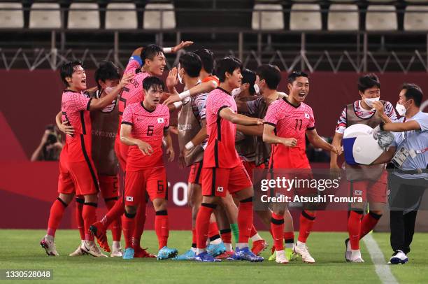 Seungwon Jeong, Dongjun Lee and teammates of Team South Korea celebrates after their side's first goal, an own goal scored by Marius Marin of Team...