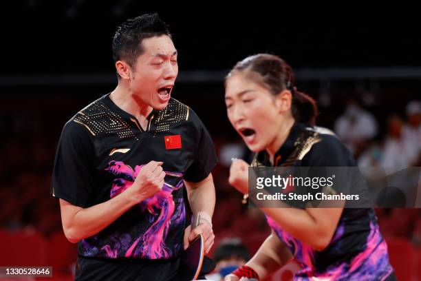 Xu Xin and Liu Shiwen of Team China react during their Mixed Doubles Semifinal match on day two of the Tokyo 2020 Olympic Games at Tokyo Metropolitan...