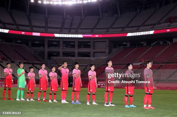 Players of Team South Korea stand for the national anthem prior to the Men's First Round Group B match between Romania and Republic of Korea on day...