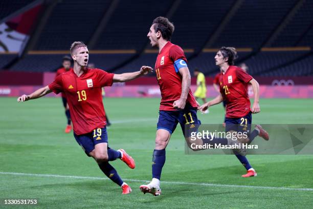 Mikel Oyarzabal of Team Spain celebrates with teammate Dani Olmo after scoring their side's first goal during the Men's First Round Group C match...
