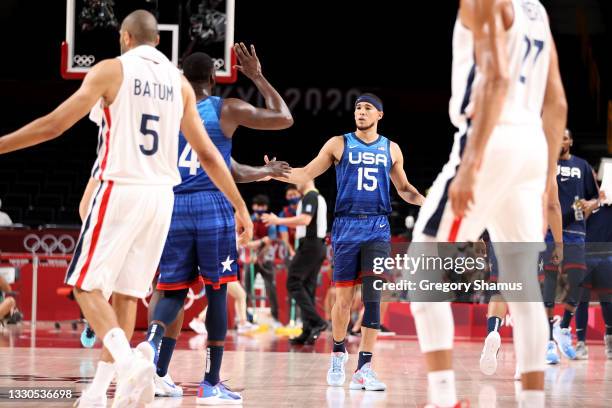 Devin Booker of Team United States high fives his teammates in the first half of the game against Team France in Men's Preliminary Round Group B...
