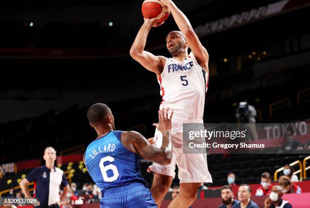 Nicolas Batum of Team France looks to pass over Damian Lillard of Team United States during the first half of the Men's Preliminary Round Group B...