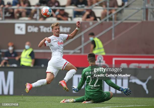 Jann-Fiete Arp of Holstein Kiel is challenged by Goalkeeper Nikola Vasilj of FC St. Pauli during the Second Bundesliga match between FC St. Pauli and...