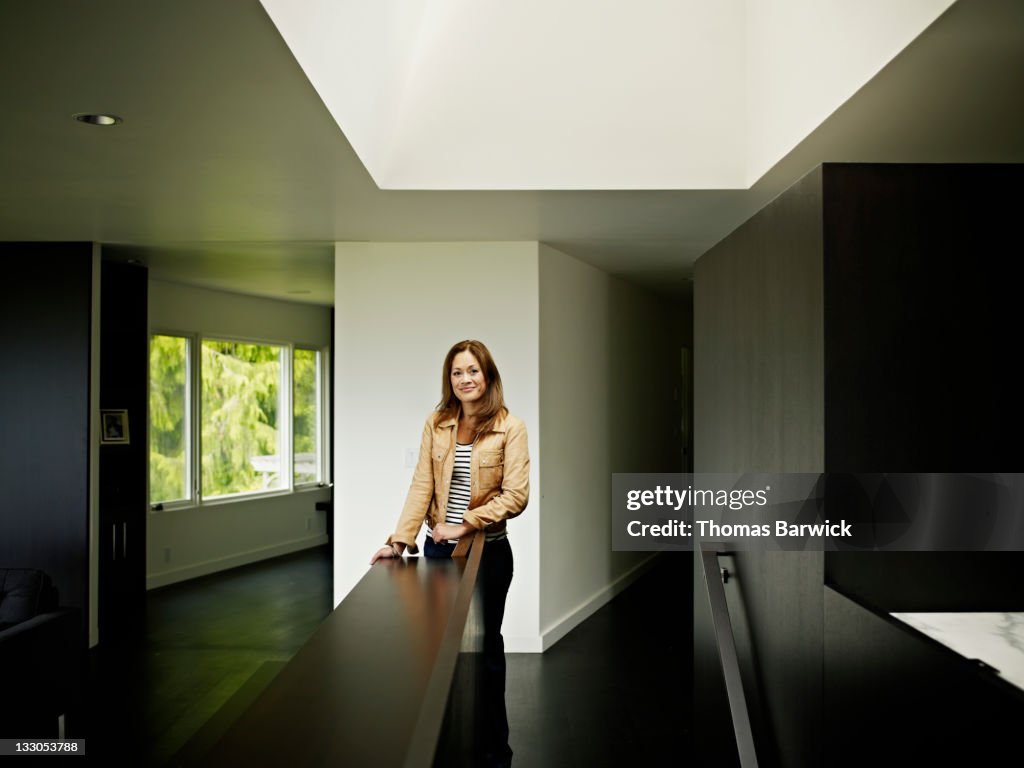 Woman standing in home under skylight