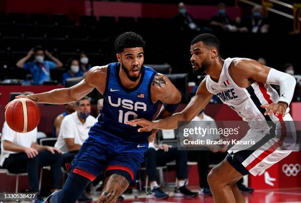 Jayson Tatum of the USA takes on the defence of Timothe Luwawu Kongbo of France during the preliminary rounds of the Men's Basketball match between...