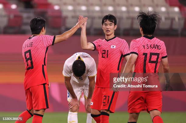 Kangin Lee of Team South Korea celebrates with teammate Jingyu Kim after scoring their side's fourth goal during the Men's First Round Group B match...