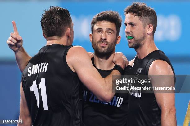 Kane Russell of Team New Zealand celebrates with teammates Jake Smith and Nick Wilson after scoring their team's third goal during the Men's...