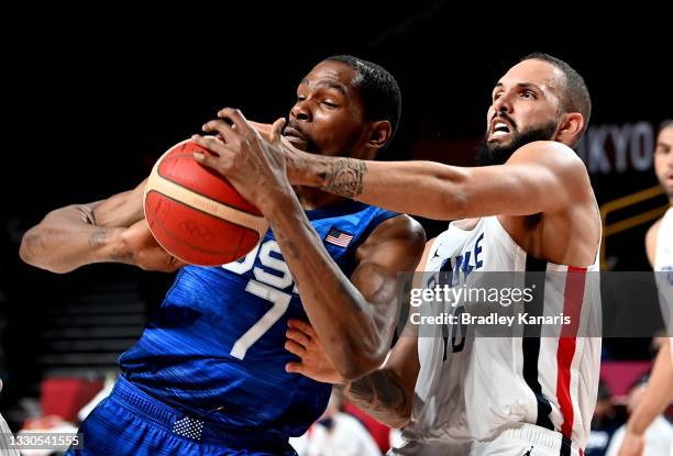 Kevin Durant of the USA is pressured by the defence of Evan Fournier of France during the preliminary rounds of the Men's Basketball match between...