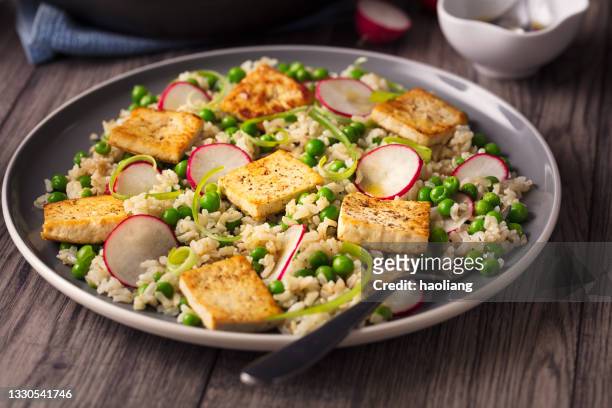 healthy vegan brown rice, peas, and grilled tofu salad - macrobiotic diet stock pictures, royalty-free photos & images