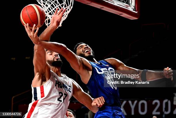 Jayson Tatum of the USA and Rudy Gobert of France challenge for the ball during the preliminary rounds of the Men's Basketball match between the USA...