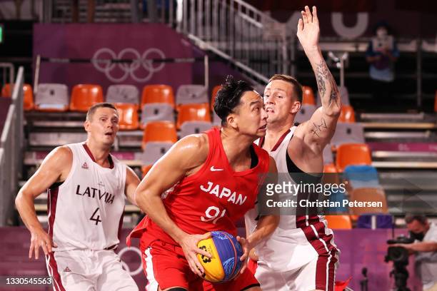 Tomoya Ochiai of Team Japan controls the ball during the Men's Pool Round match between Latvia and Japan on day two of the Tokyo 2020 Olympic Games...