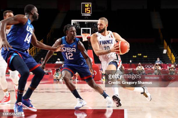 Evan Fournier of Team France drives to the basket against Jrue Holiday of Team United States during the second half of the Men's Preliminary Round...