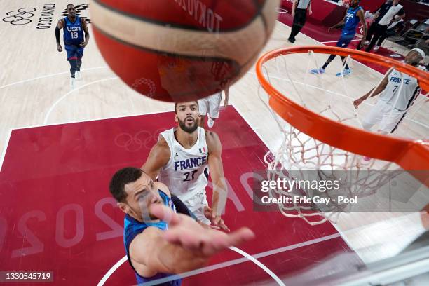 Zachary Lavine of Team United States drives past Rudy Gobert of Team France for a layup during the second half of the Men's Preliminary Round Group B...