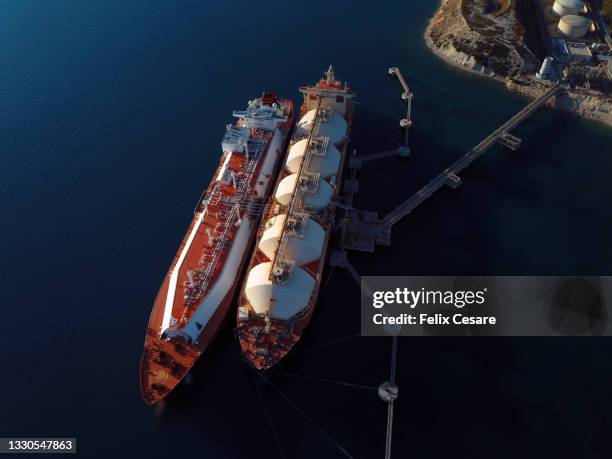 aerial view of two ship tankers supplying chemicals to the power station. - tanker ship stock pictures, royalty-free photos & images