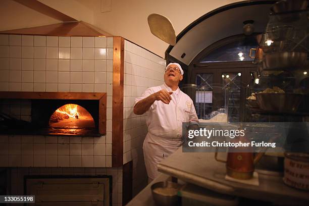 Pizza chef Pepe Mazza spins the dough in the world reknowned Lombardi Pizzeria on November 16, 2011 in Naples, Italy. Italian Prime Minster designate...