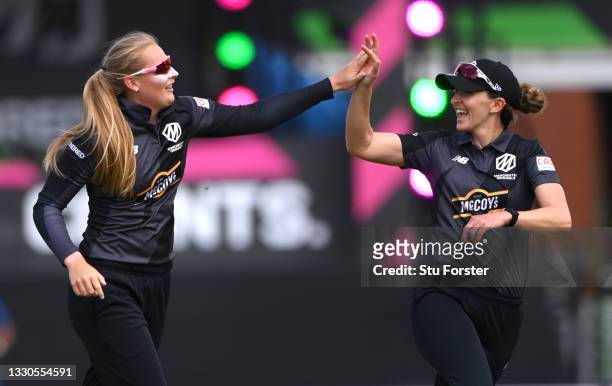 Originals bowler Sophie Ecclestone celebrates with Kate Cross after taking the wicket of Amy Jones during the Hundred match between Manchester...