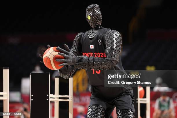 Robot plays basketball during halftime of the Men's Preliminary Round Group B game between the United States and France on day two of the Tokyo 2020...
