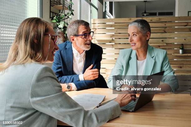a financial advisor meeting with clients - lawyer stock-fotos und bilder