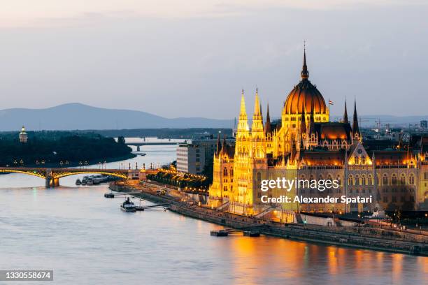 budapest skyline with illuminated hungarian parliament building and danube river at dusk, hungary - hungarian parliament building stock pictures, royalty-free photos & images