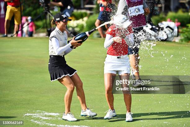 Tournament winner Minjee Lee of Australia celebrates with Lydia Ko of New Zealand on the eighteenth green during day four of the The Amundi Evian...