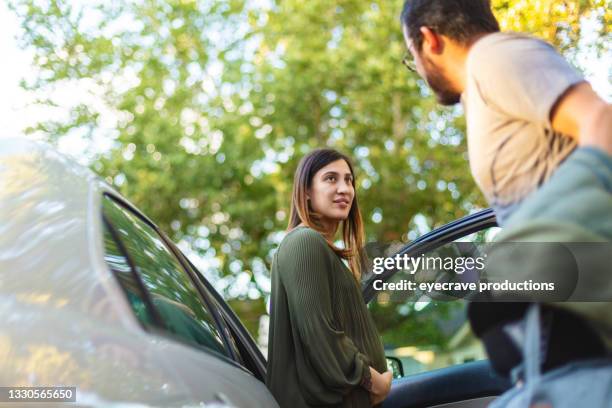 hispanic husband and wife packing car to go to hospital maternity in labor photo series - pregnant woman car stock pictures, royalty-free photos & images