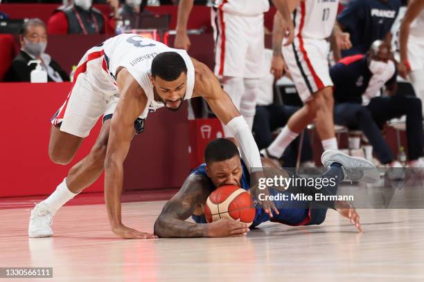 Timothe Luwawu Kongbo of Team France and Damian Lillard of Team United States dive for possession of the ball during the second half of the Men's...