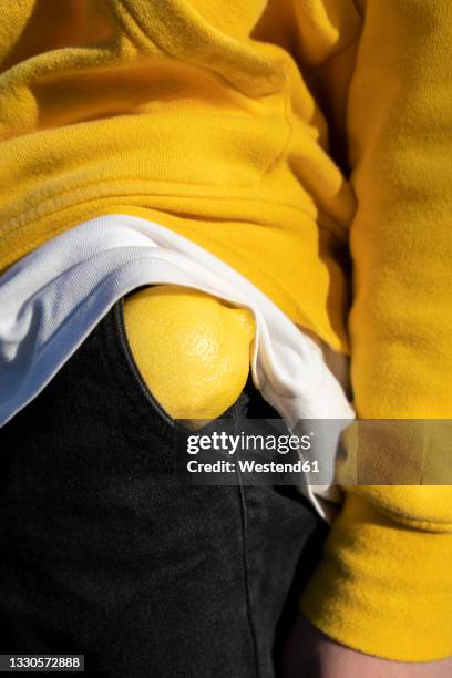 boy with lemon in pocket - pocket ストックフォトと画像