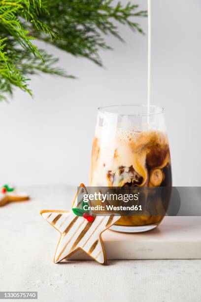 star shaped christmas cookie and glass of iced coffee - christmas coffee stock pictures, royalty-free photos & images