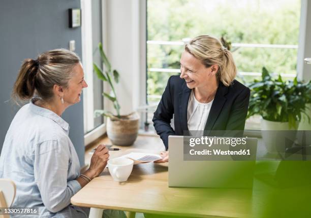 customer having discussion with financial advisor at office - advice home imagens e fotografias de stock