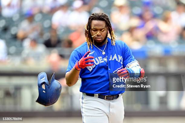 Vladimir Guerrero Jr. #27 of the Toronto Blue Jays tosses his helmet after flying out against the New York Mets during the third inning at Citi Field...