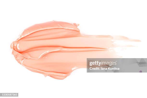 beautiful delicate pink smear of bb face cream on white background isolated. tonal foundation is smudged. products for makeup and skin care. organic cosmetics. cosmetology. moisturizing cream. - pink lipstick stock-fotos und bilder